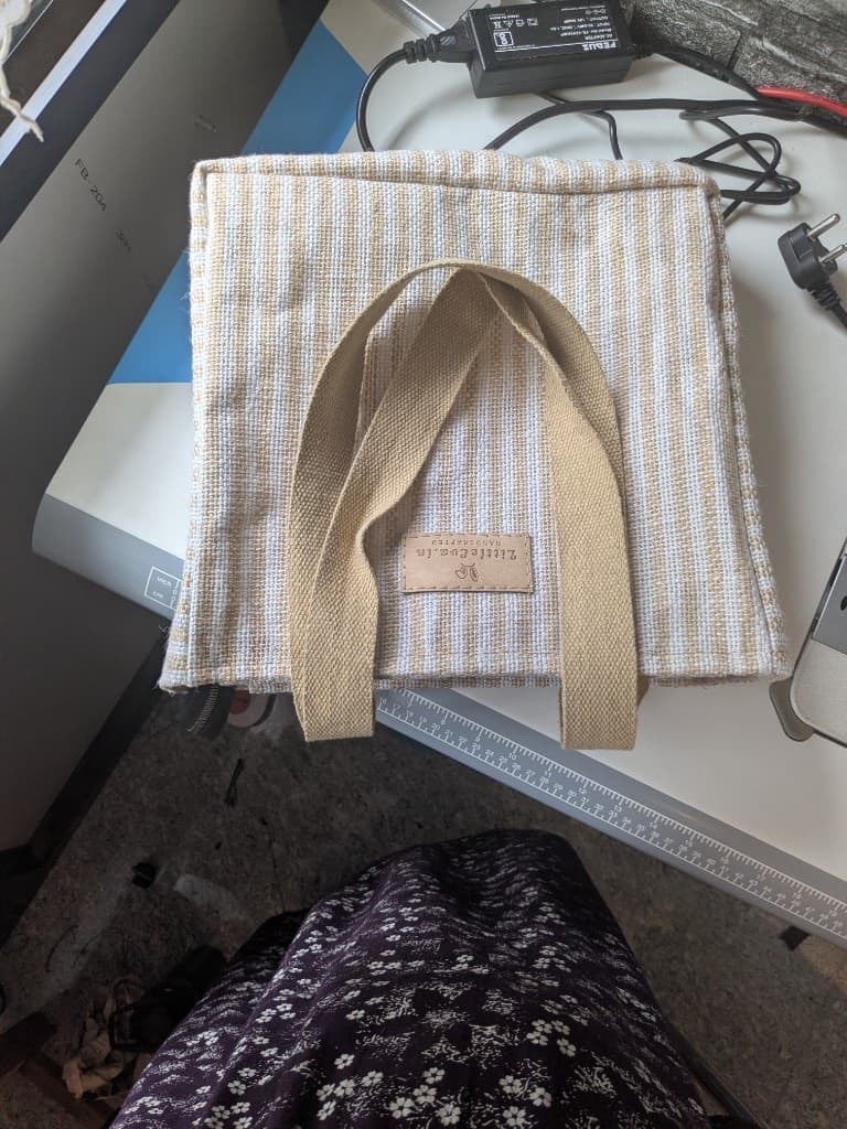 Assembled striped tote bag on the sewing table with the LittleEva.in leather label stitched on