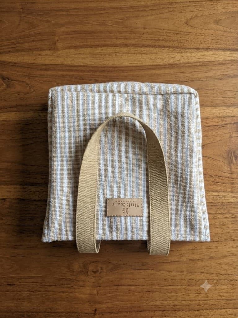 Finished striped tote bag with the LittleEva.in leather label, photographed flat on dark wood